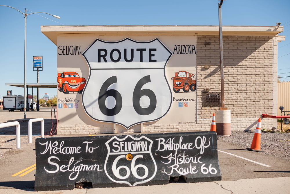 a route 66 sign in front of a building