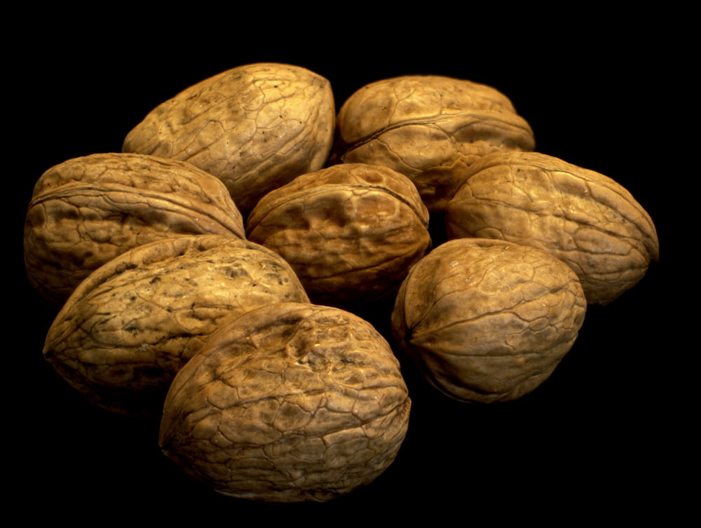 a pile of walnuts on a black background