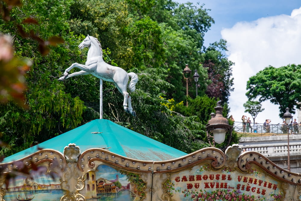 a carousel with a horse statue on top of it