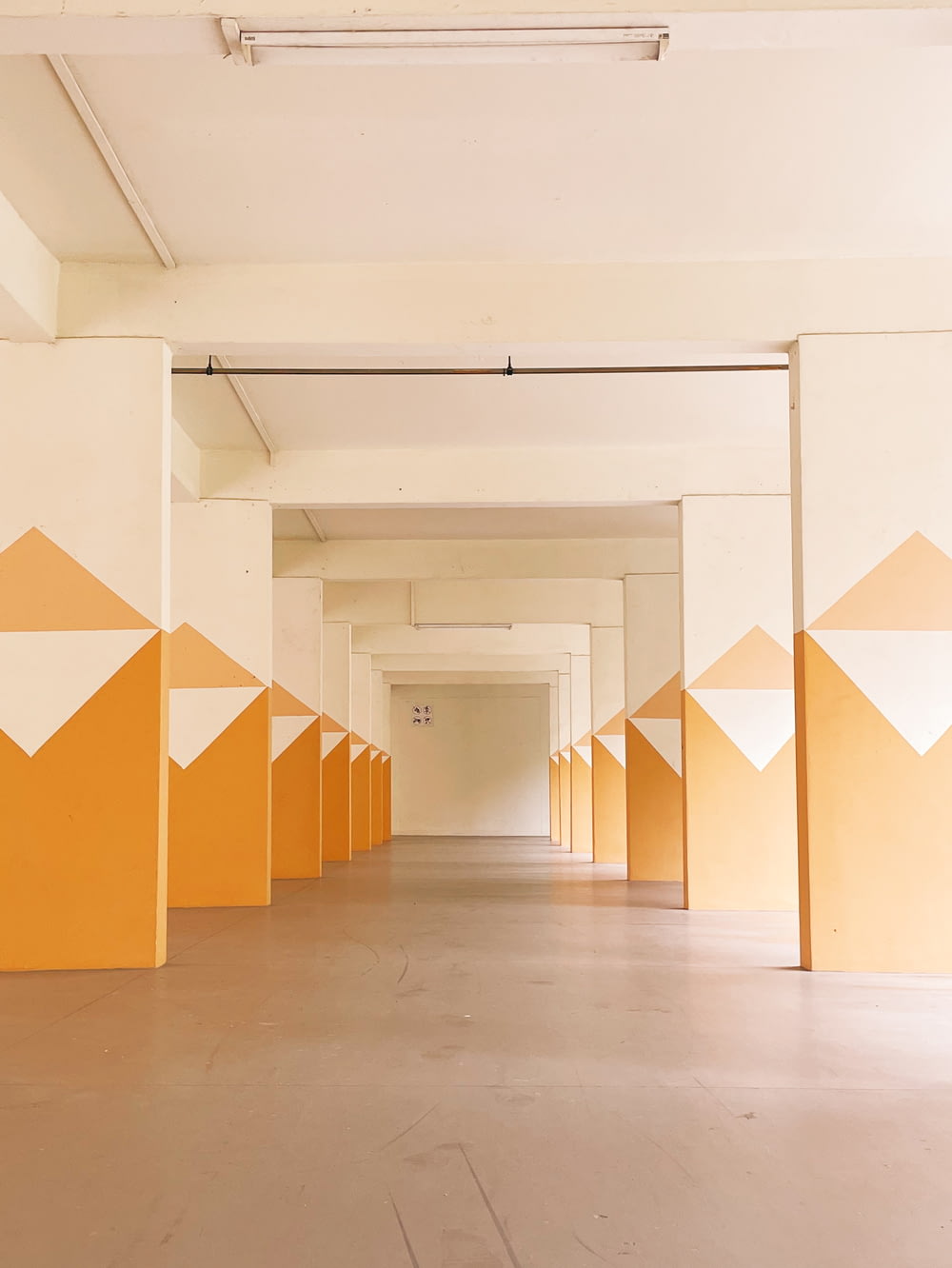 a long hallway with orange and white painted walls