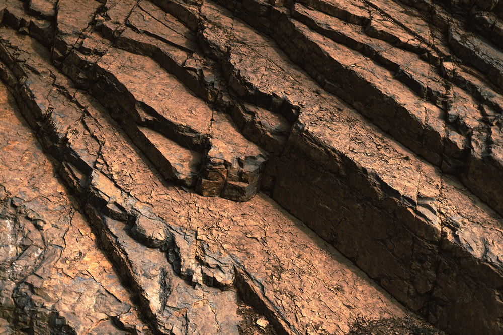 a close up of a rock wall with cracks in it