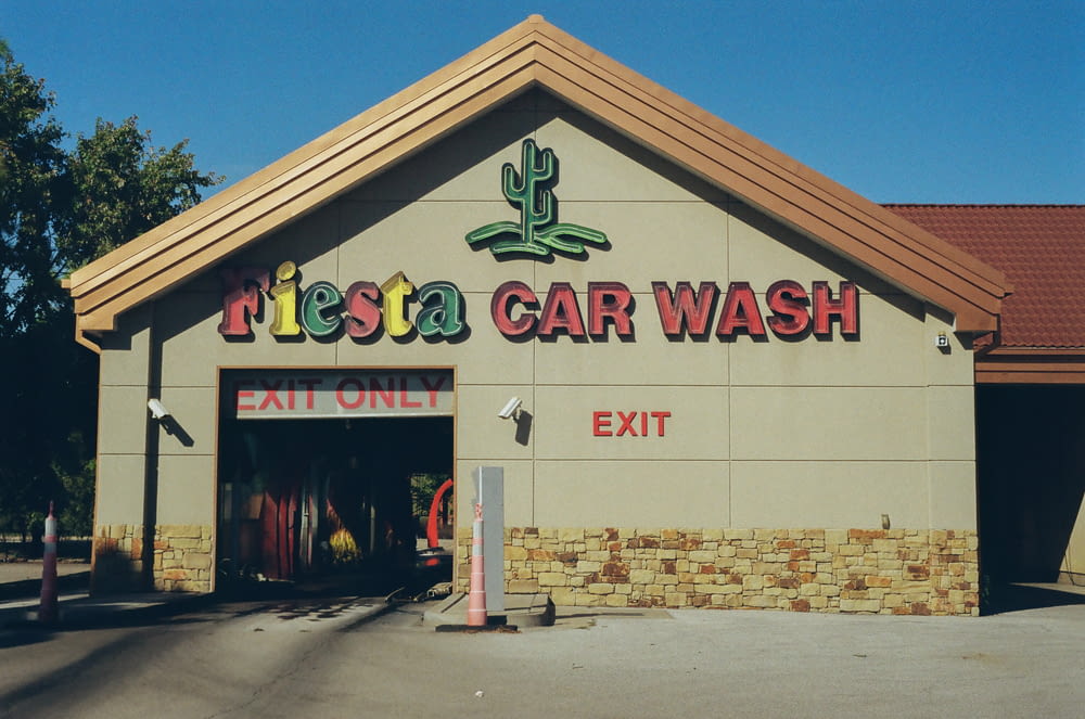 a car wash building with a sign that says fiesta car wash
