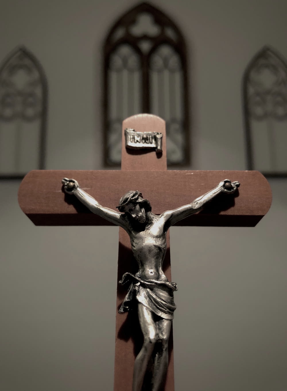 a cross with a statue of jesus on it