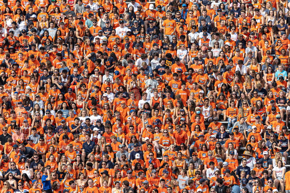 a large group of people in orange shirts