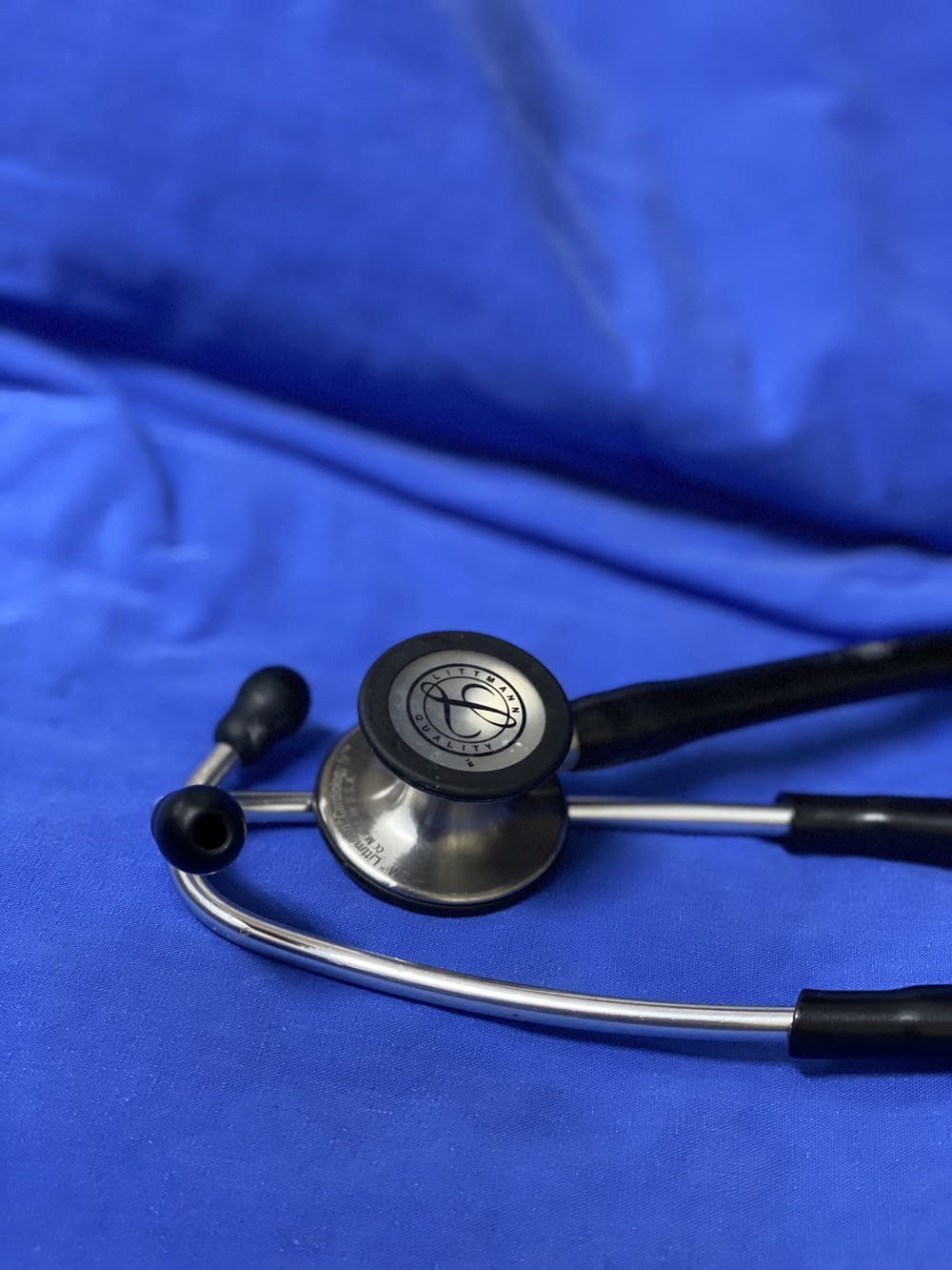 a stethoscope laying on top of a blue sheet
