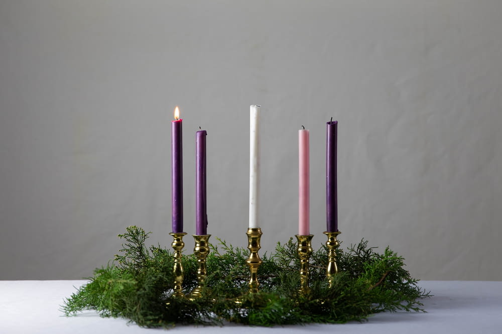 a group of three candles sitting on top of a table