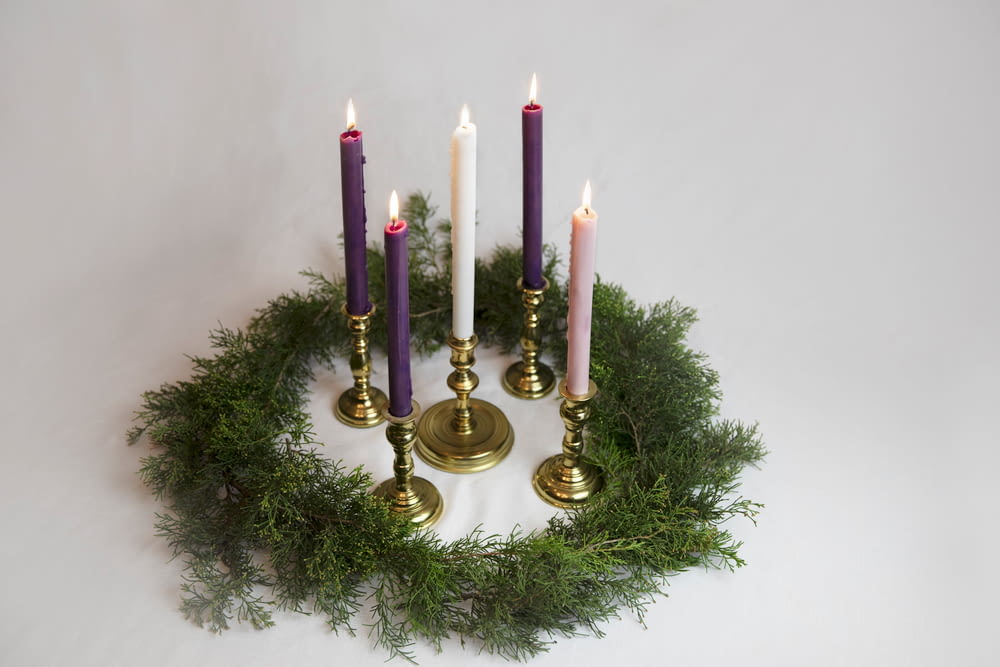 a group of candles sitting on top of a wreath