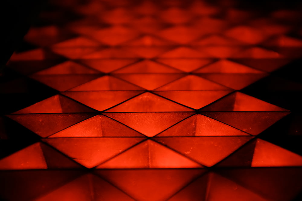 a close up of a shiny surface with red lights