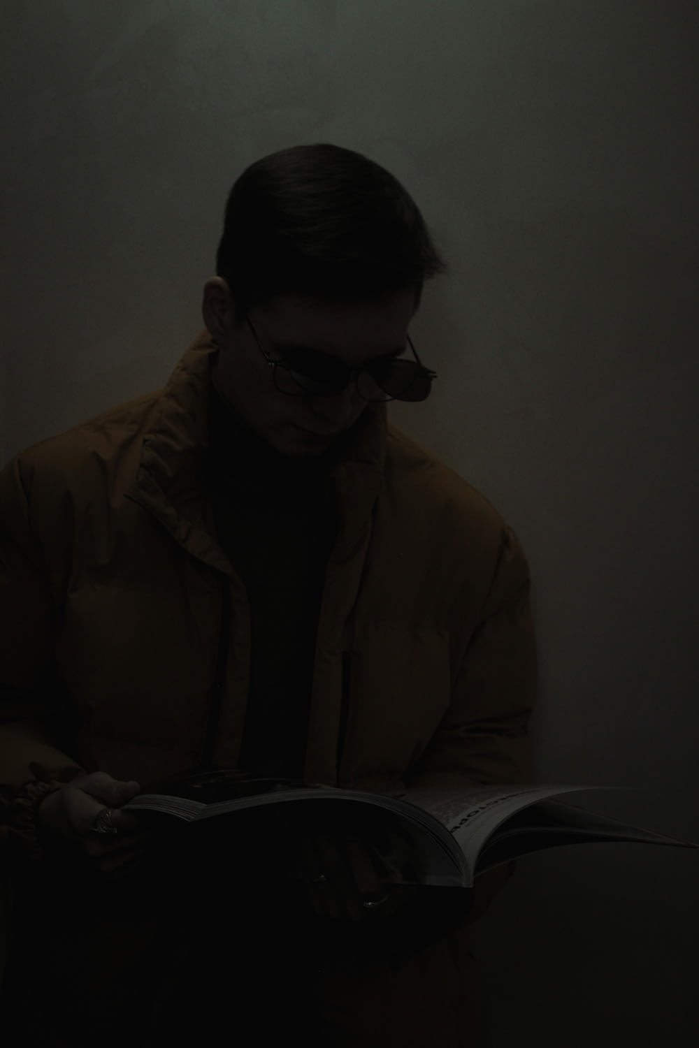 a man reading a book in the dark