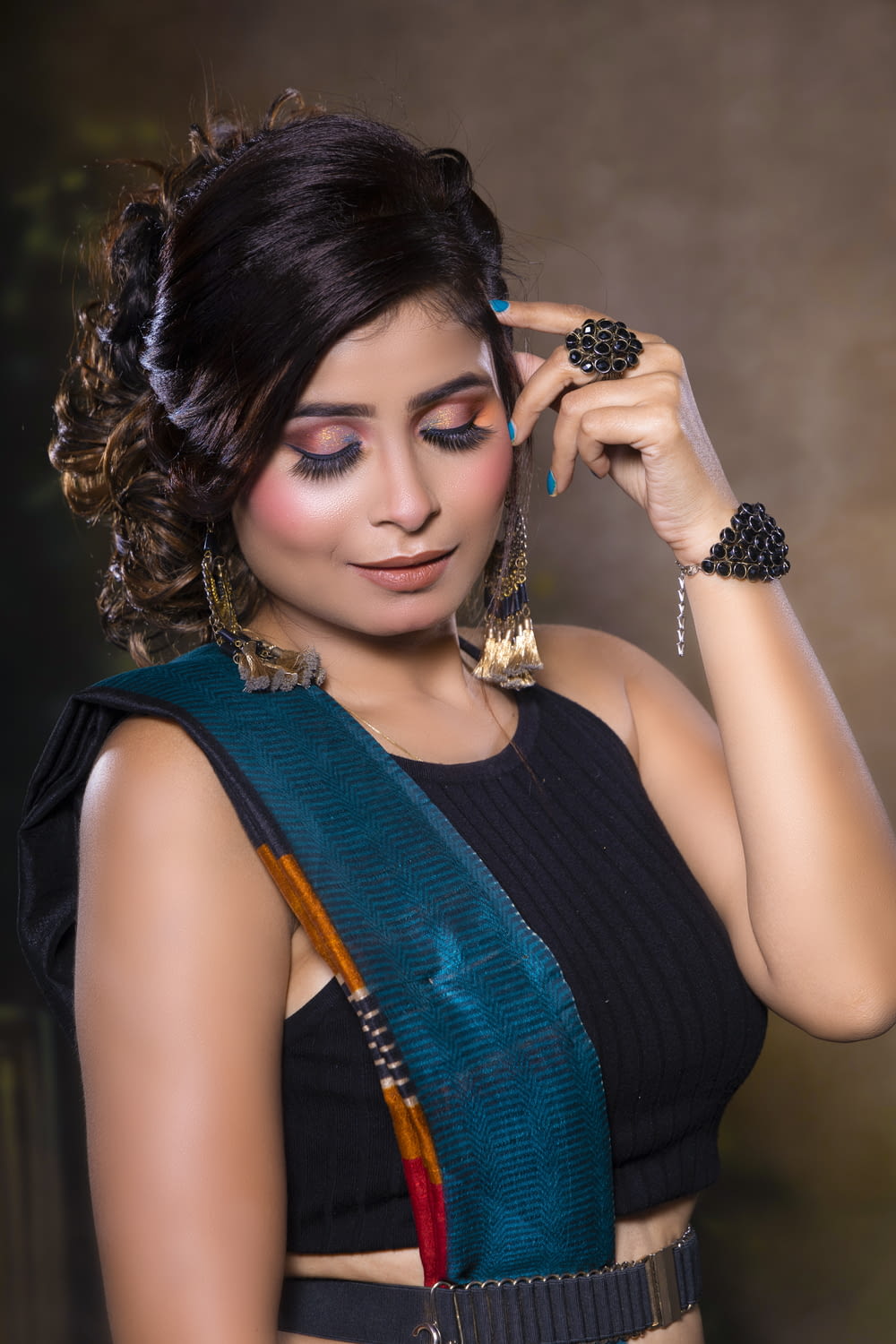 a woman in a black top and a green and blue sari