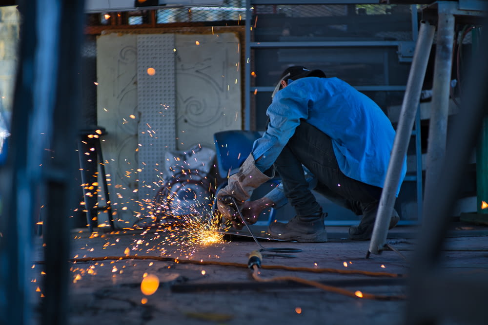 a man grinding metal with a grinder