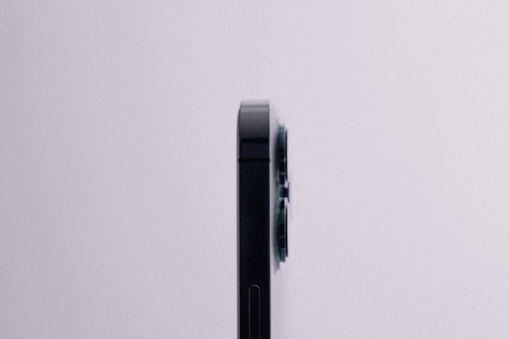 a close up of a cell phone on a white surface