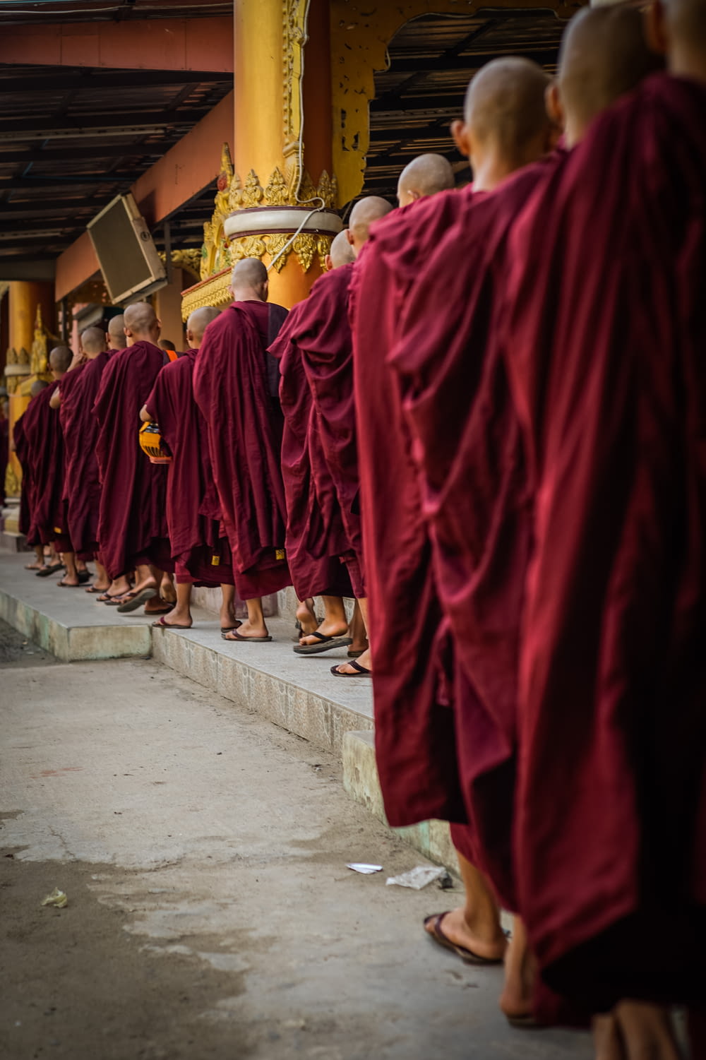 a group of monks standing in a line