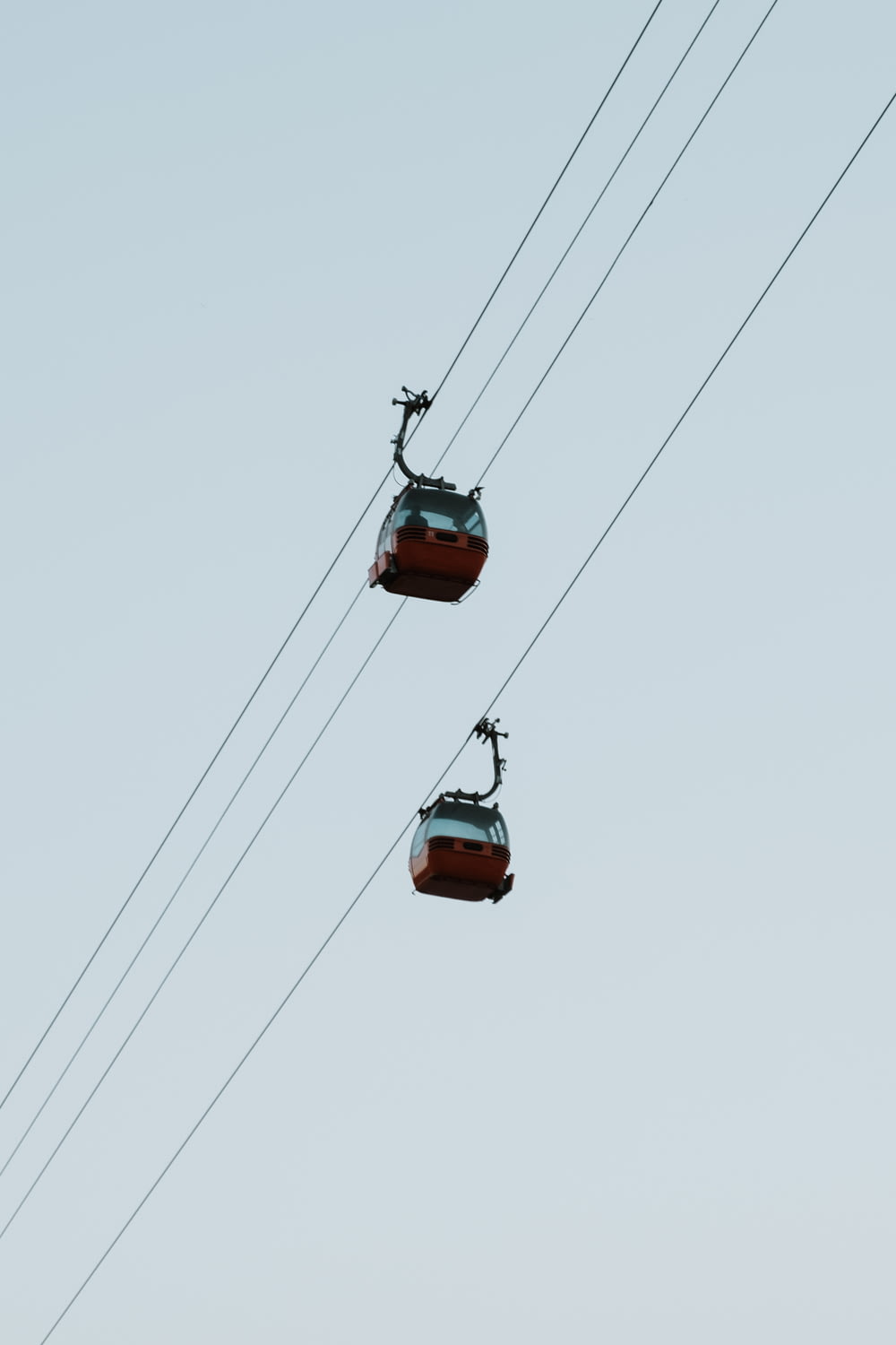 a couple of cable cars hanging from a wire