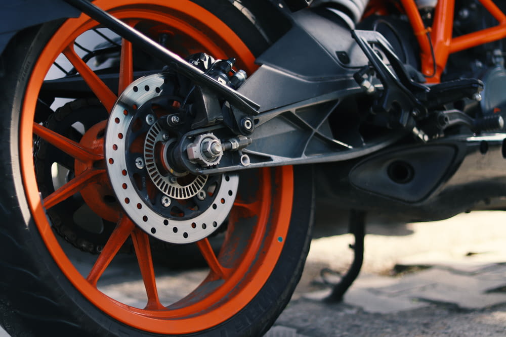 a close up of a motorcycle tire with orange rims
