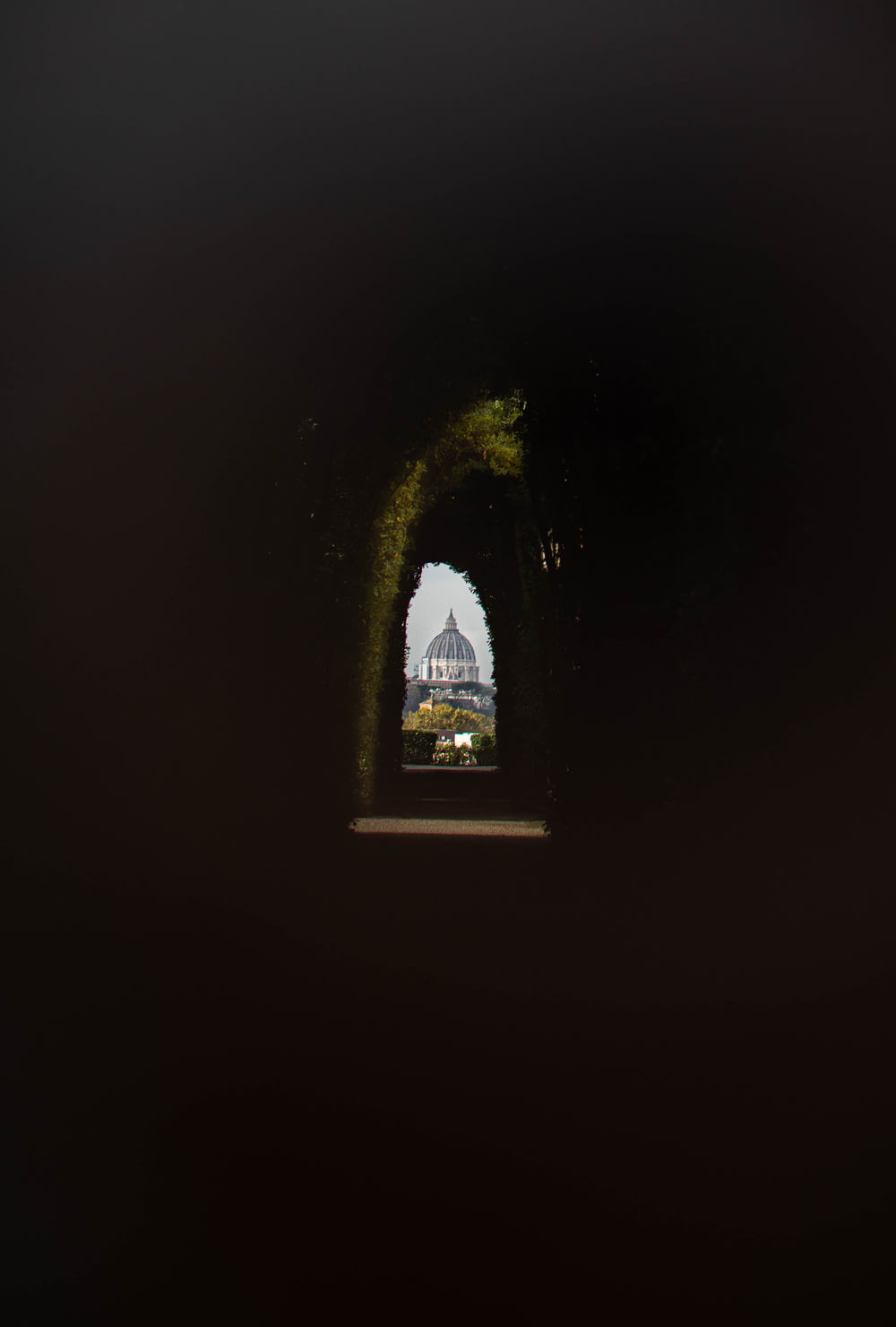 a view of a building through a tunnel