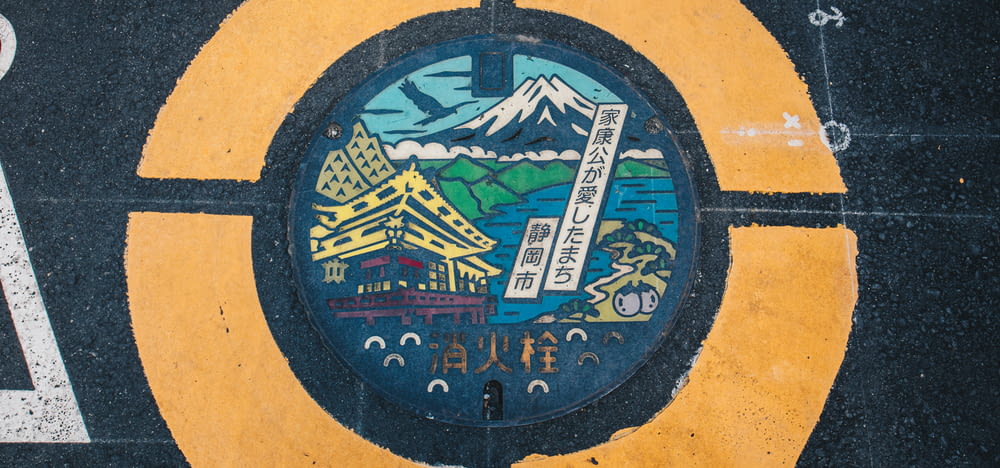 a close up of a street sign with a mountain in the background