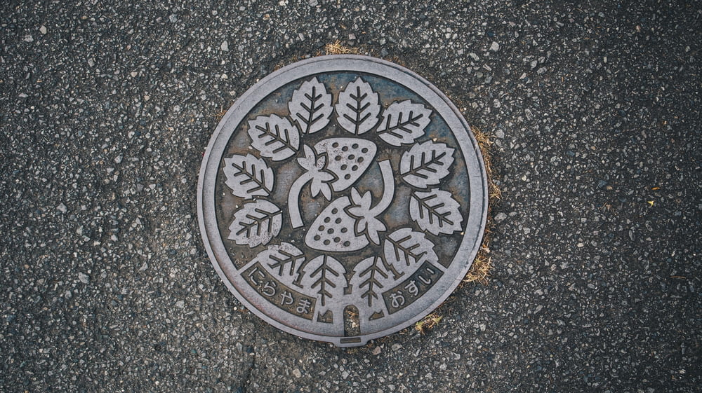 a manhole cover with a tree design on it