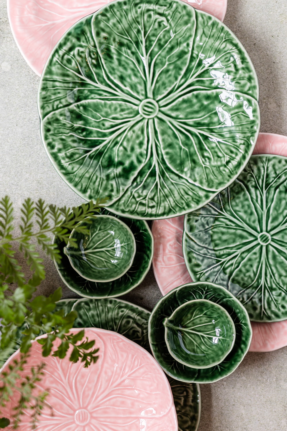 a group of green and pink plates sitting on top of a table