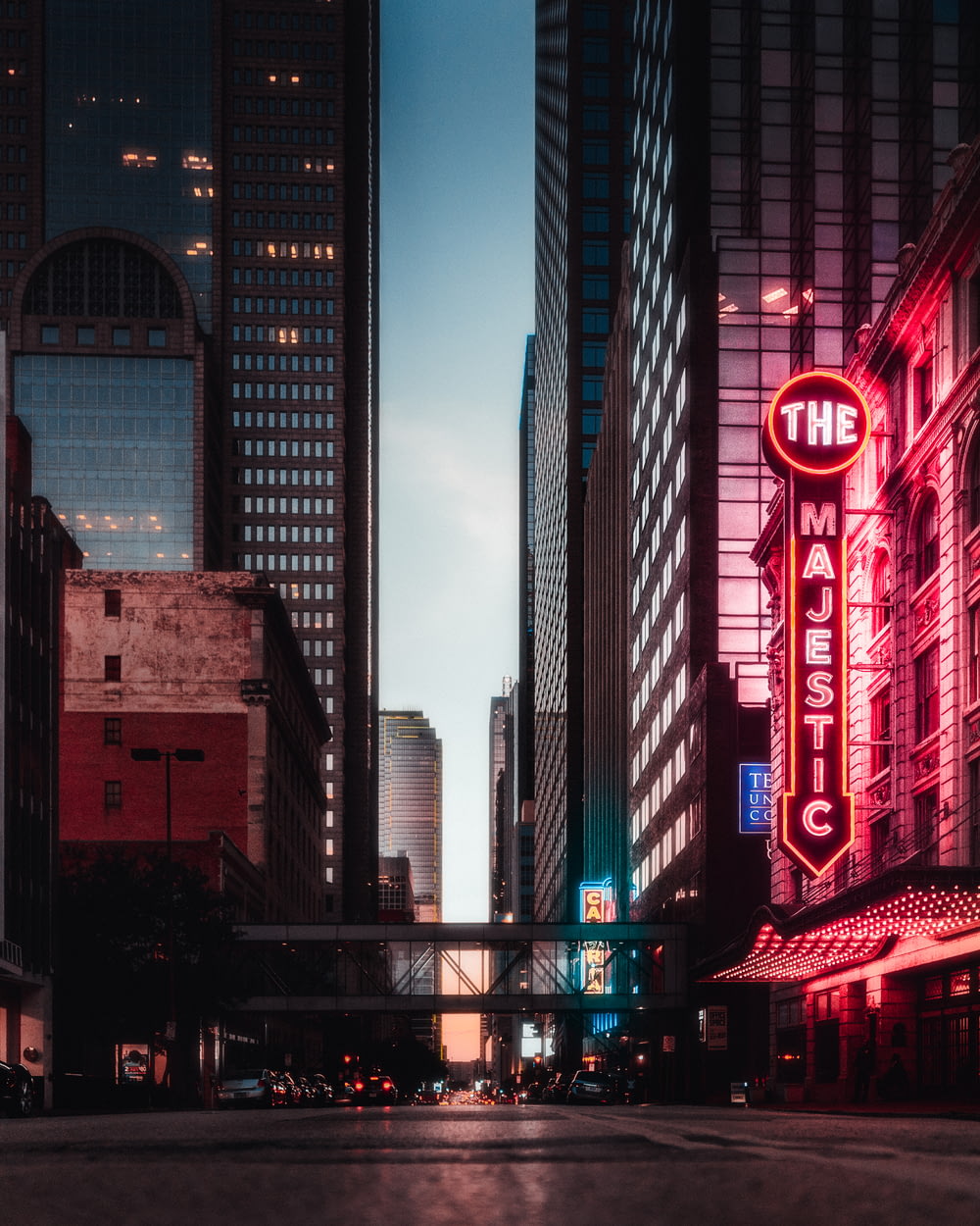 a city street filled with tall buildings and neon signs