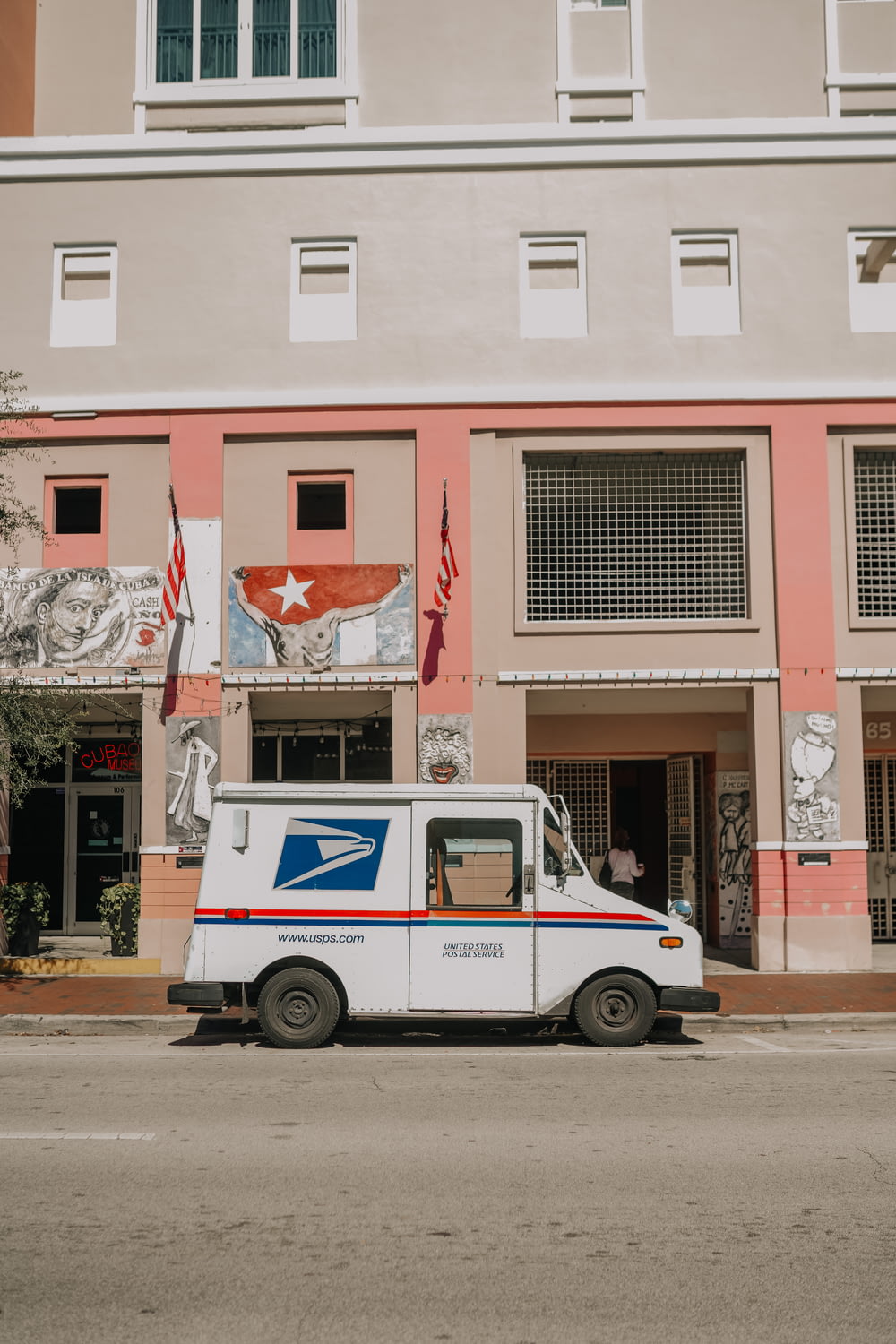 a mail truck parked in front of a building