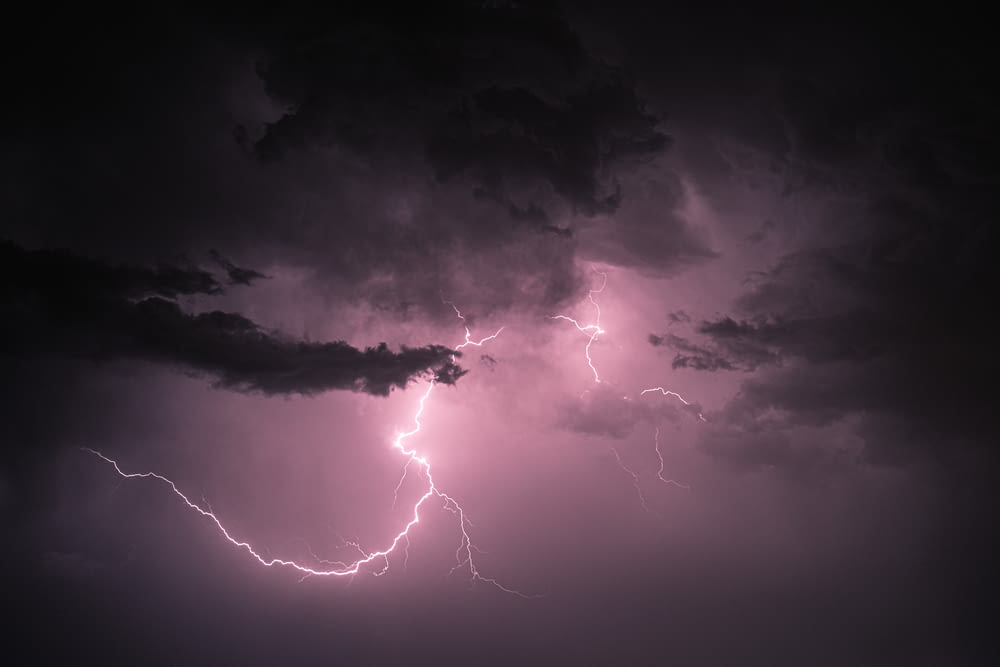a lightning bolt hitting through a dark cloudy sky