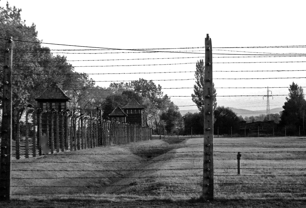 a black and white photo of a fenced in area