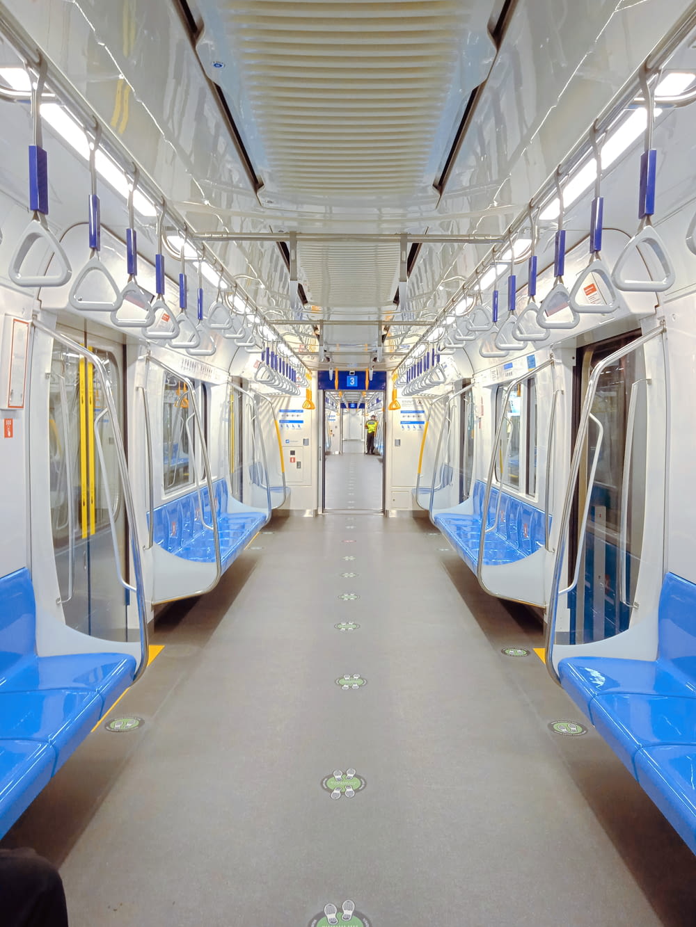 a subway car with blue and white seats