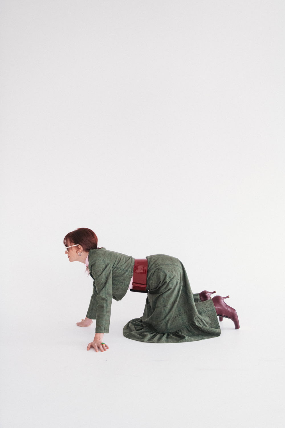 a man in a green suit laying on the ground
