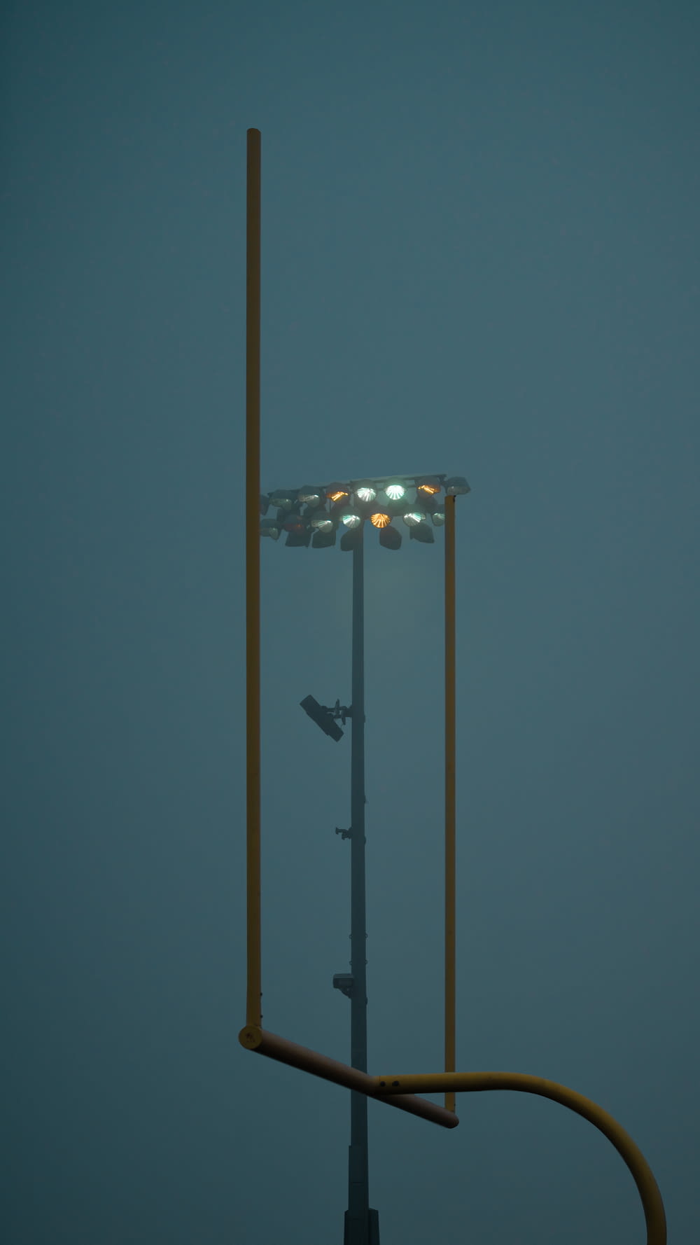 a tall light pole with a street light on top of it