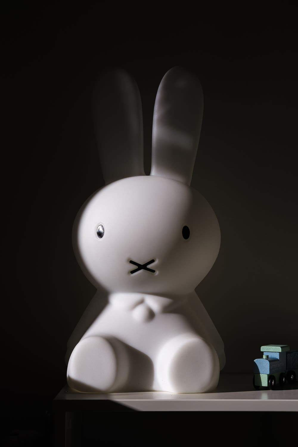 a white rabbit sitting on top of a table