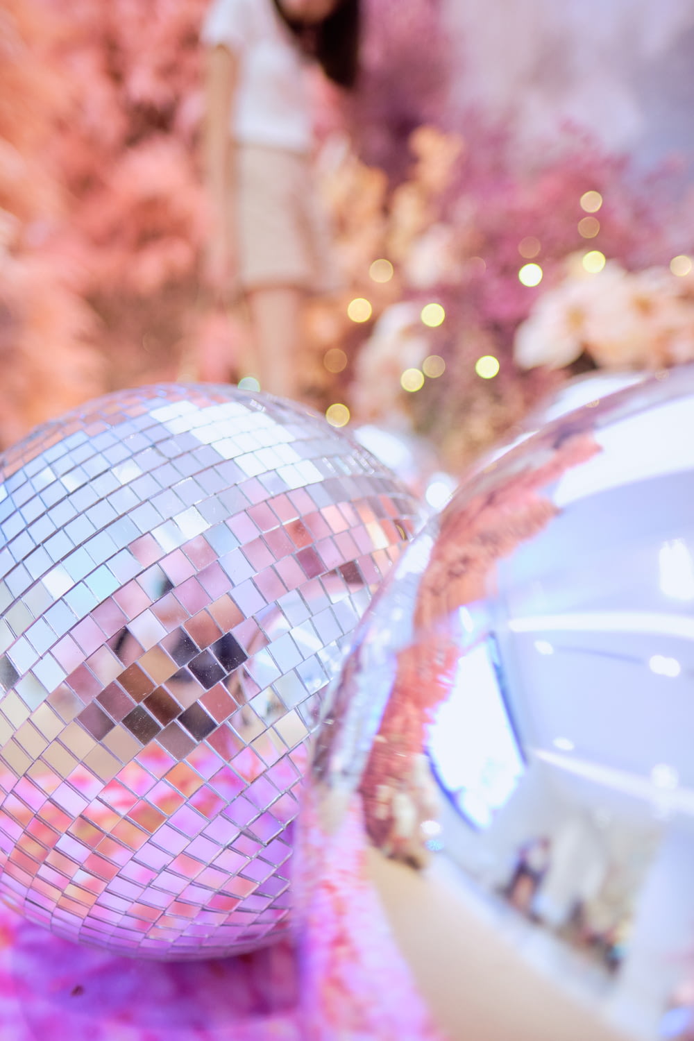 a shiny disco ball sitting on top of a pink blanket