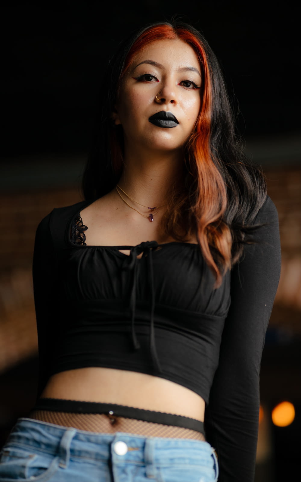 a woman with red hair and black lipstick