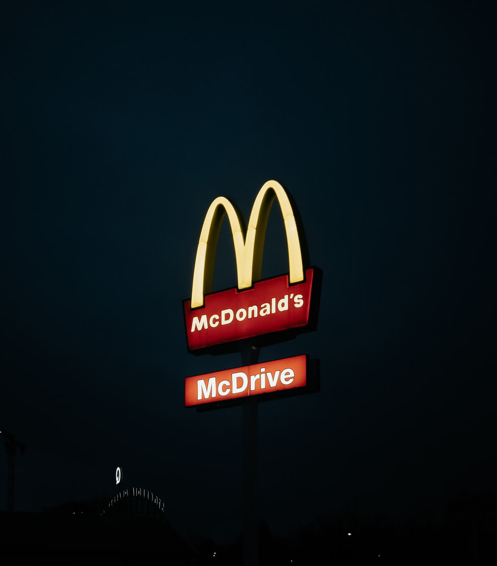 a mcdonald's restaurant sign lit up at night