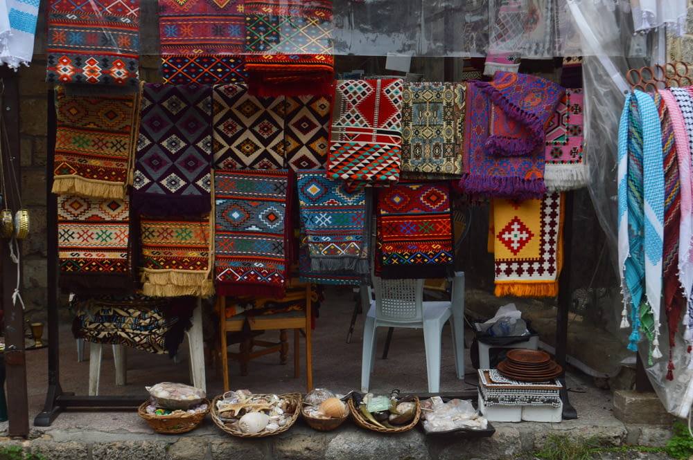 a display of colorful carpets and rugs in a shop