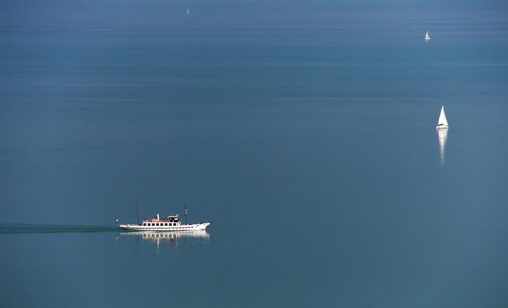 a boat floating in the middle of a large body of water