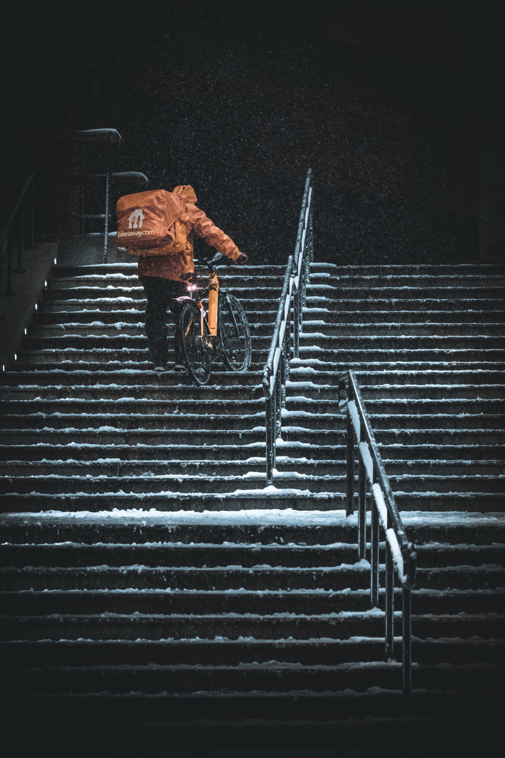 a person riding a bike down some steps