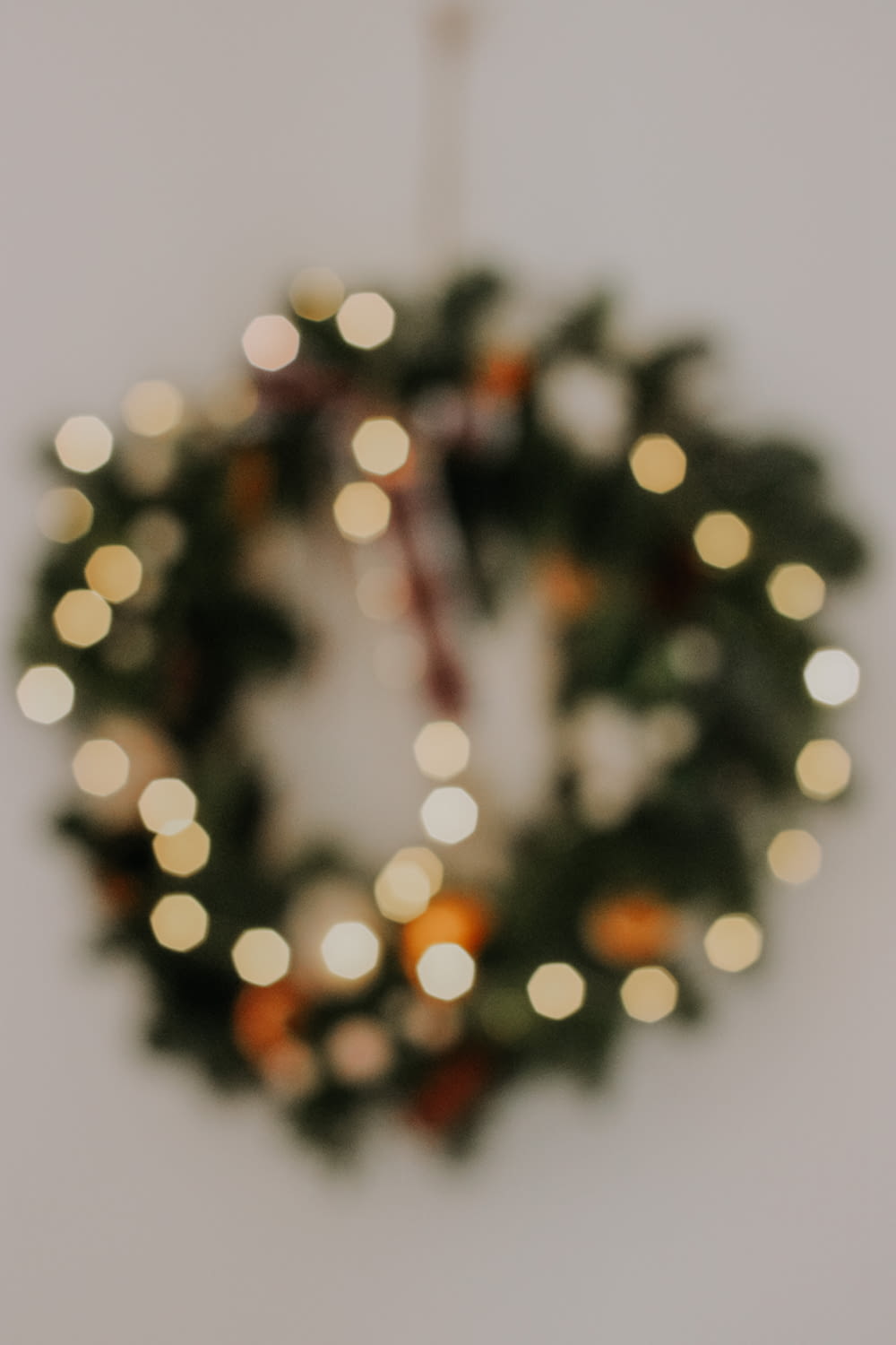 a close up of a christmas wreath on a wall