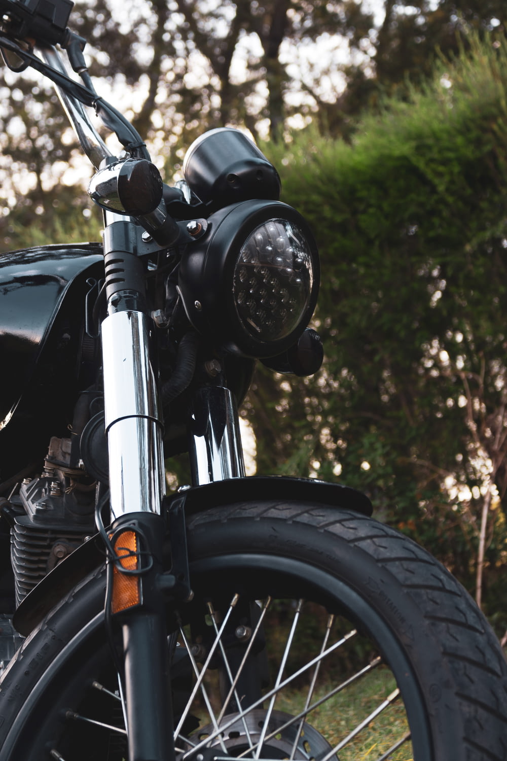 a close up of a motorcycle parked in a field
