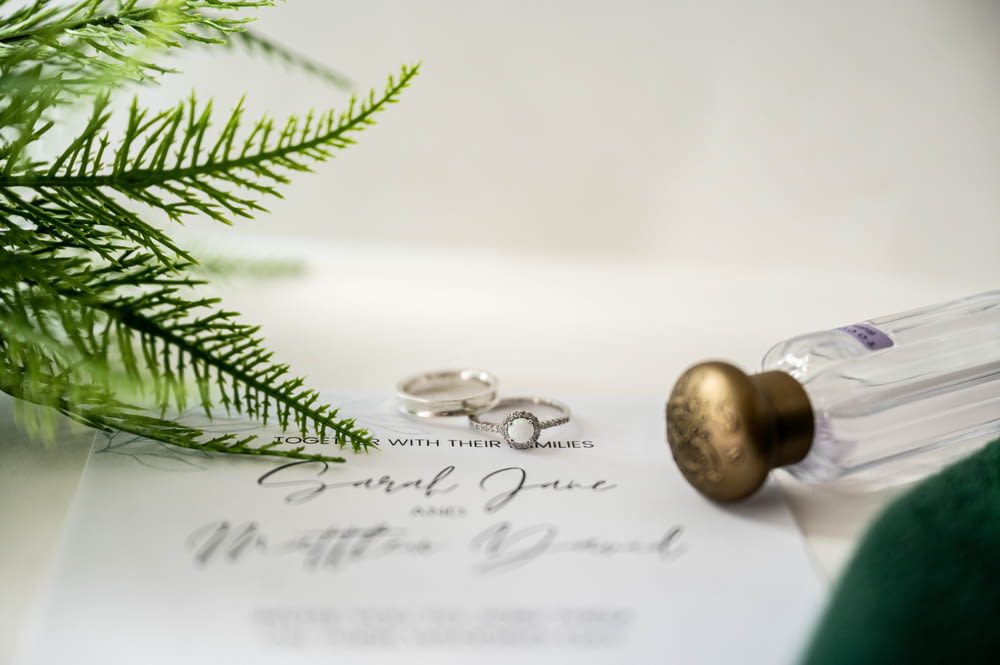 two wedding rings sitting on top of a paper