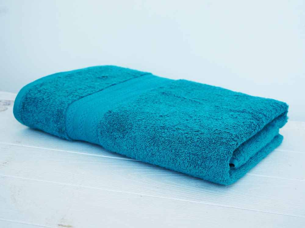 a blue towel sitting on top of a white table