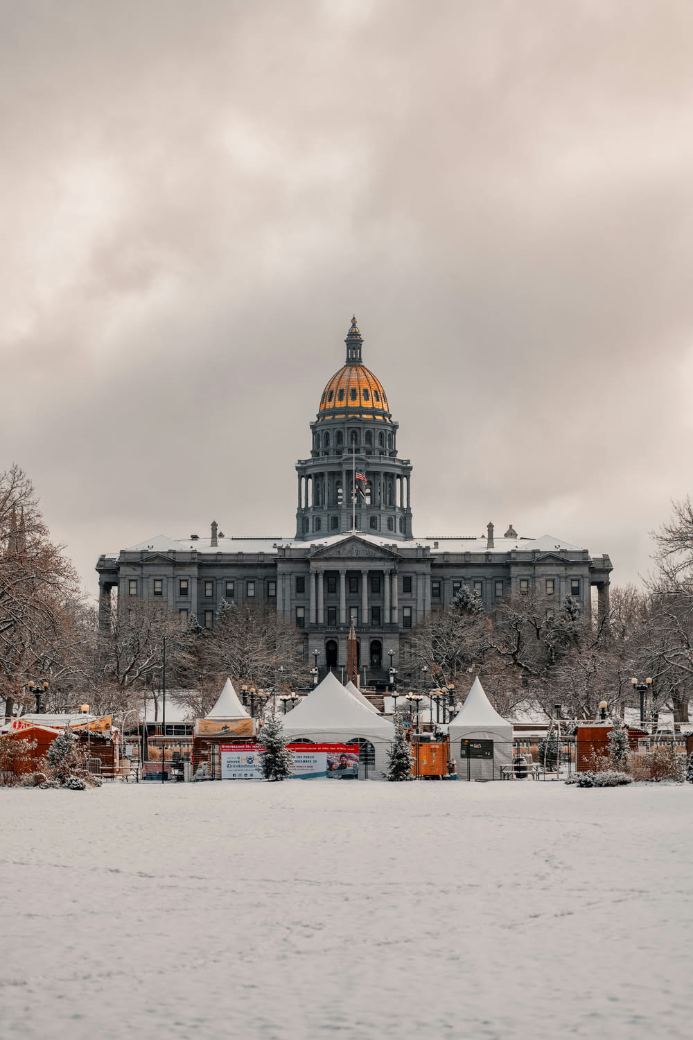 a large building with a dome in the middle of a snowy field