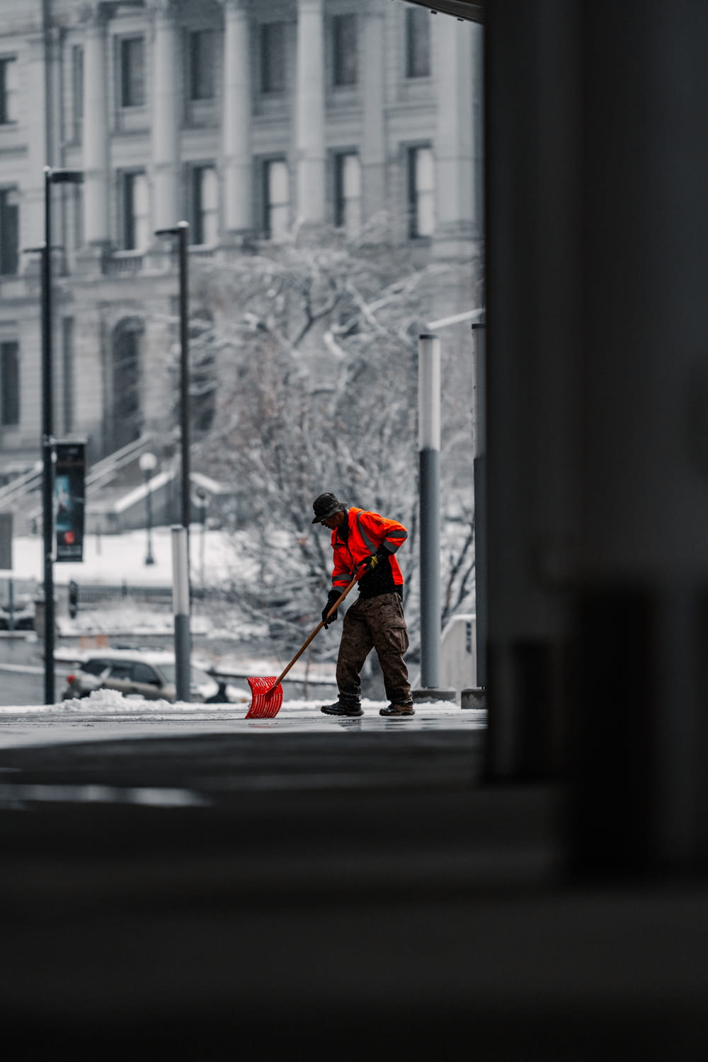 a man sweeping the street with a broom