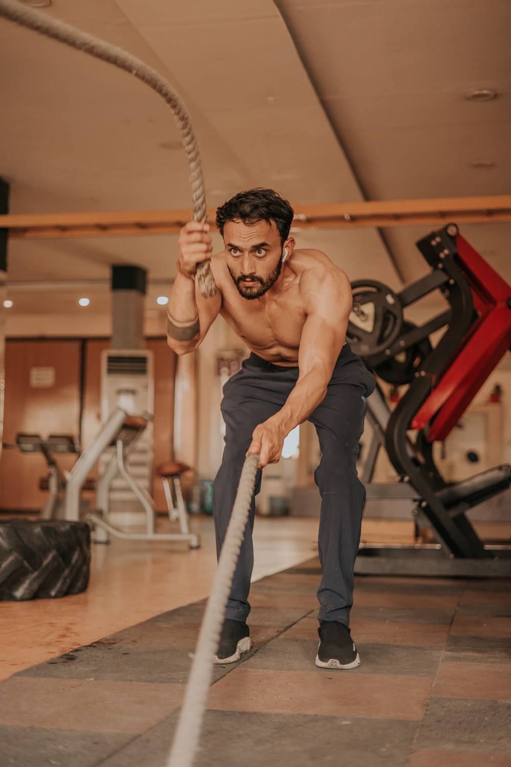 a man is doing exercises with a rope in a gym