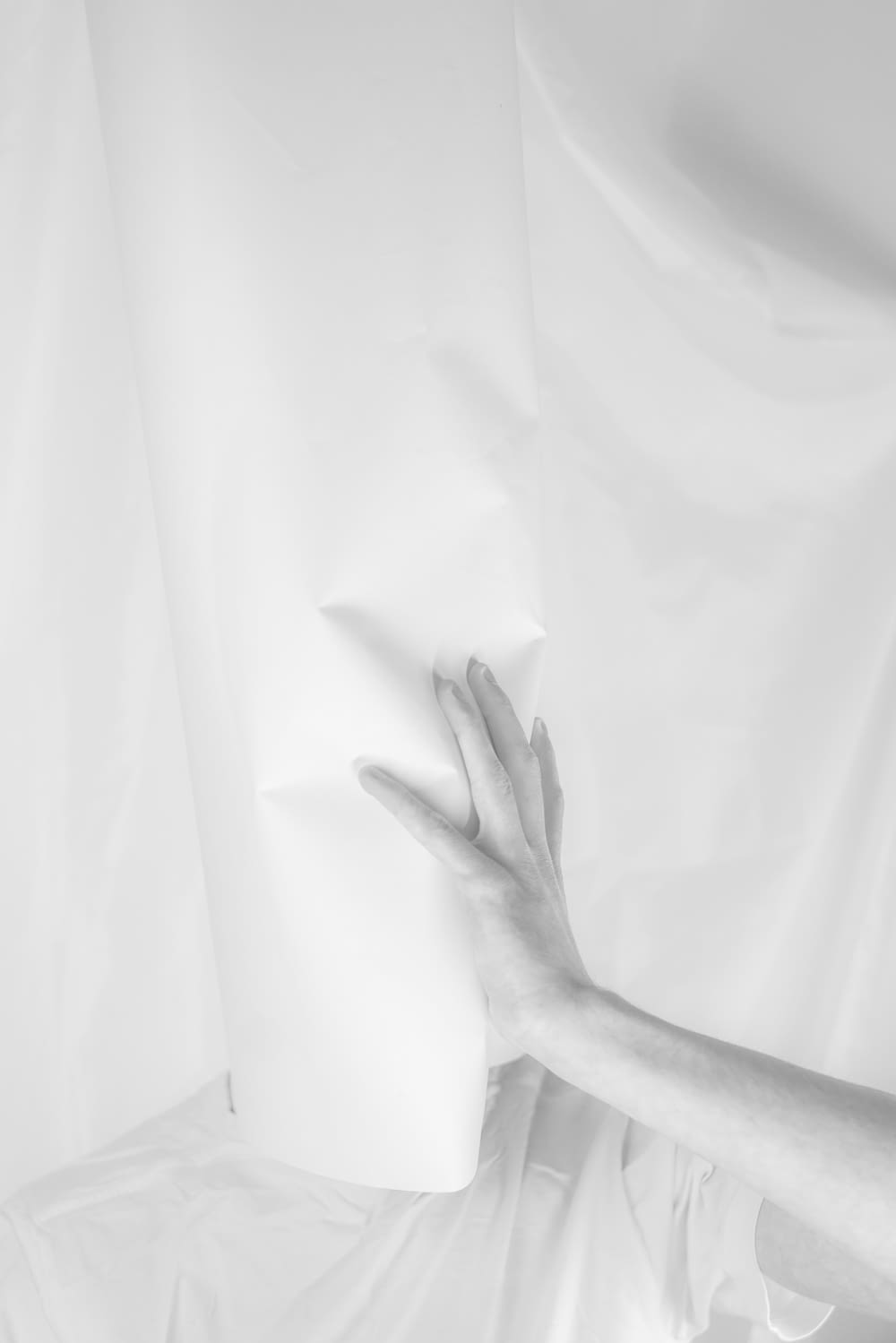 a person's hand on a sheet of white paper