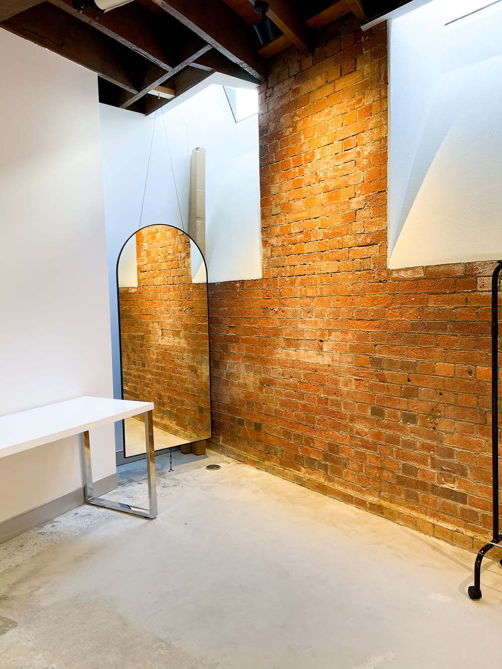 a room with a brick wall and a white table