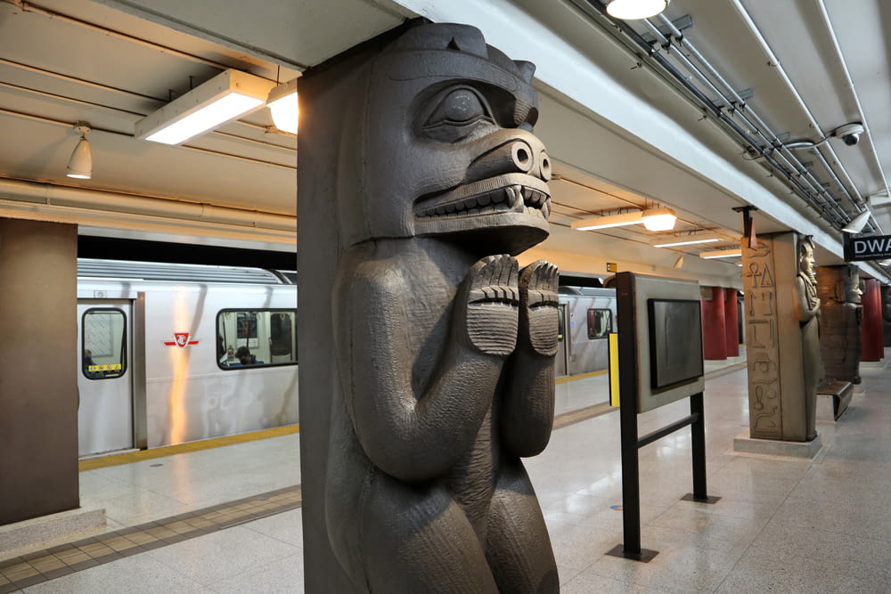 a statue of a monkey is in a subway station