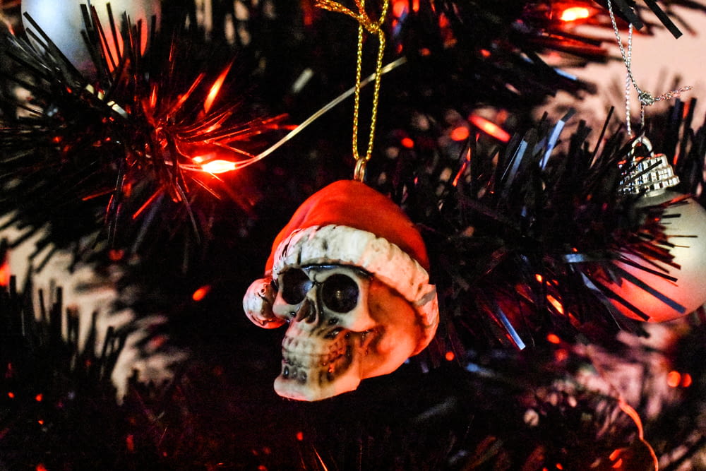 a skull ornament hanging from a christmas tree