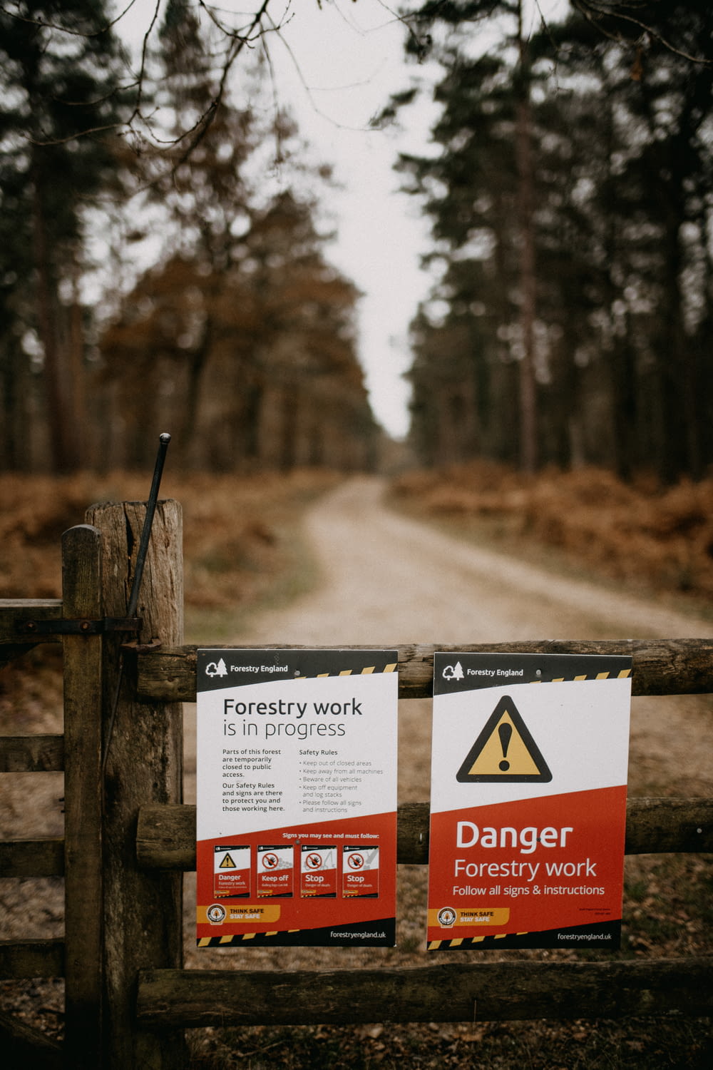 a sign on a fence warning of forest work