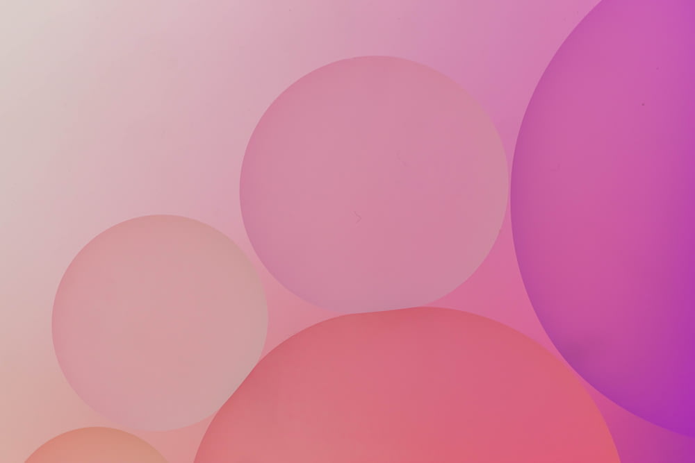 a pink and purple background with circles
